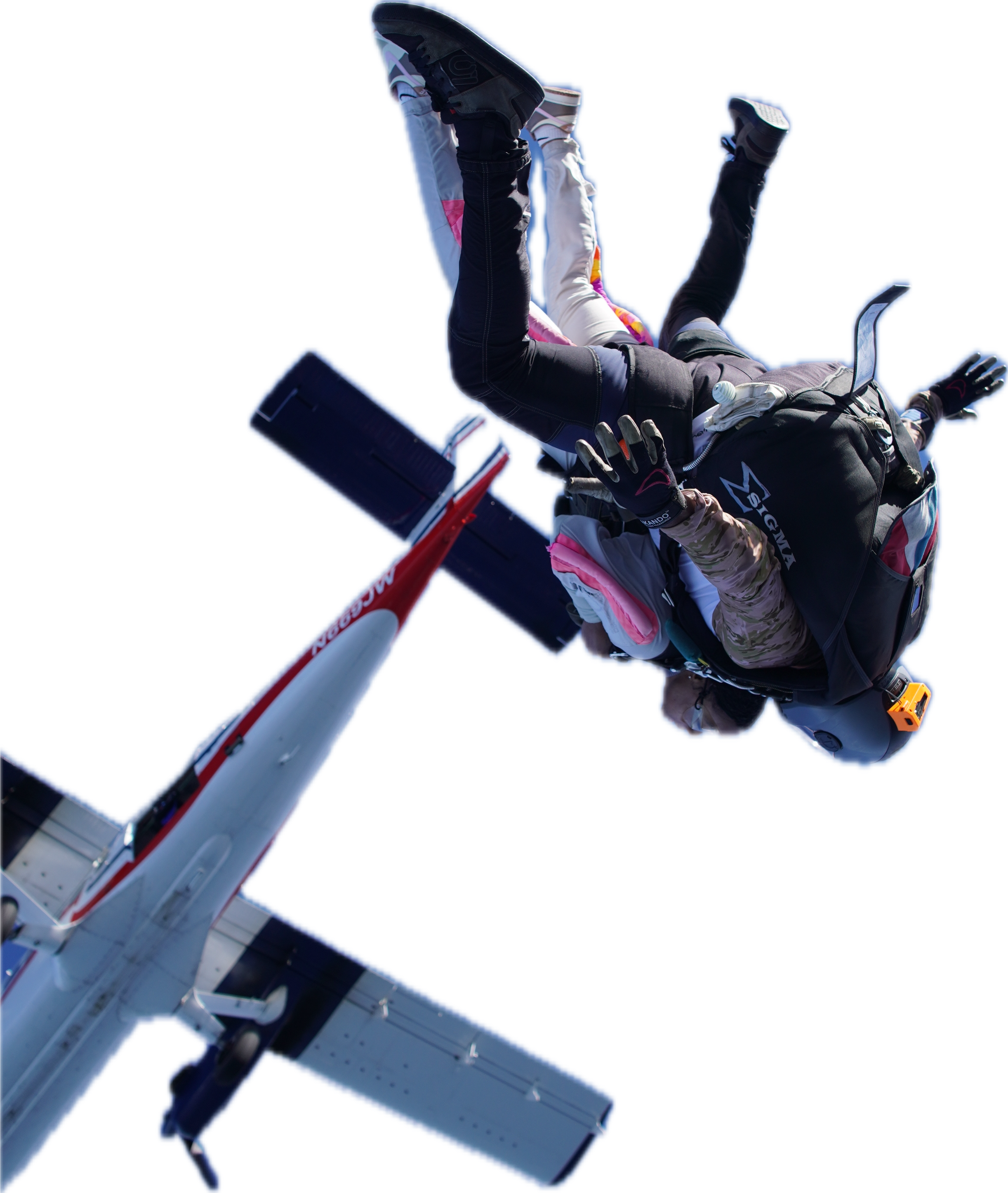 Skydivers in freefall beside an aircraft