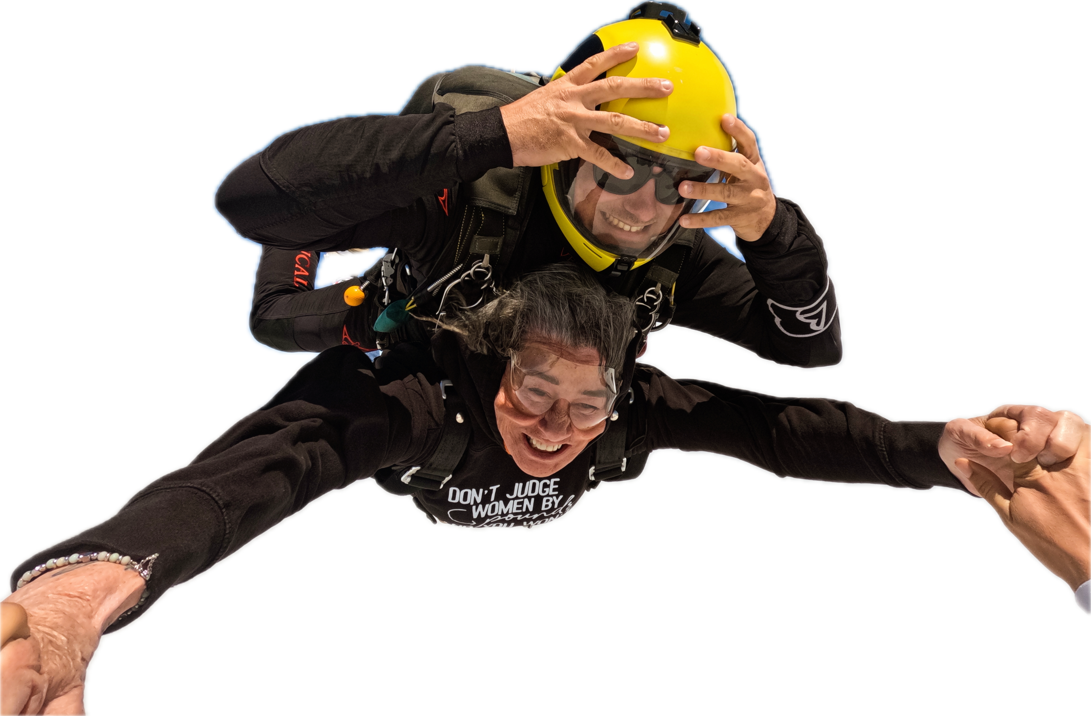 Skydiver holding a helmet in freefall